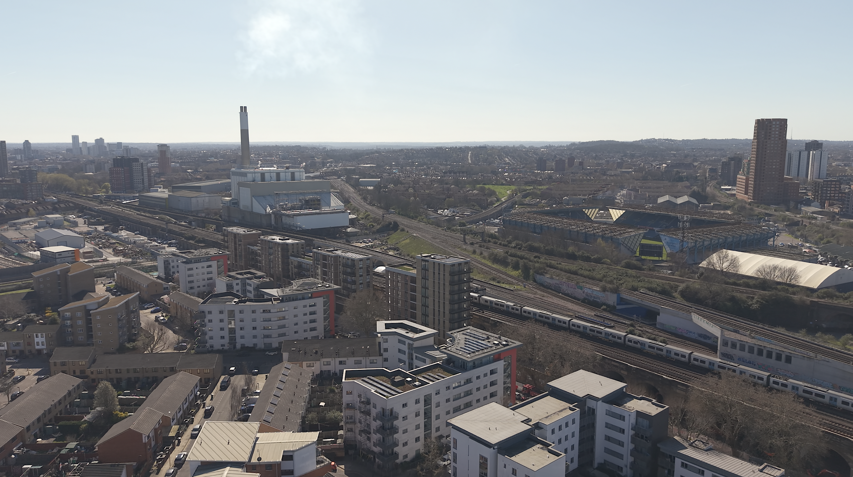 Aerial view over London Bridge with railway lines and a football stadium
