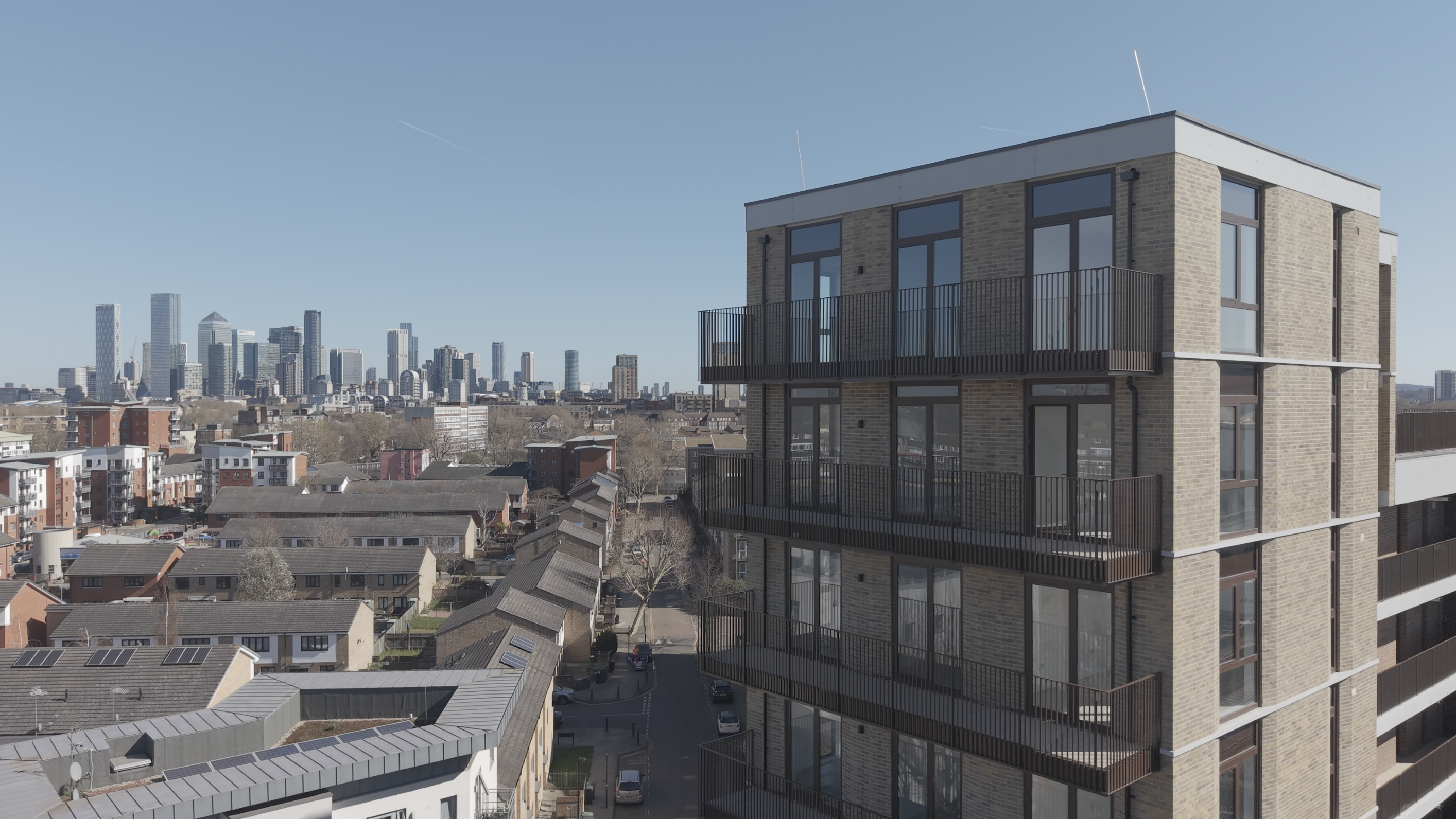 Aerial view of a residential development with the Canary Wharf skyline behind